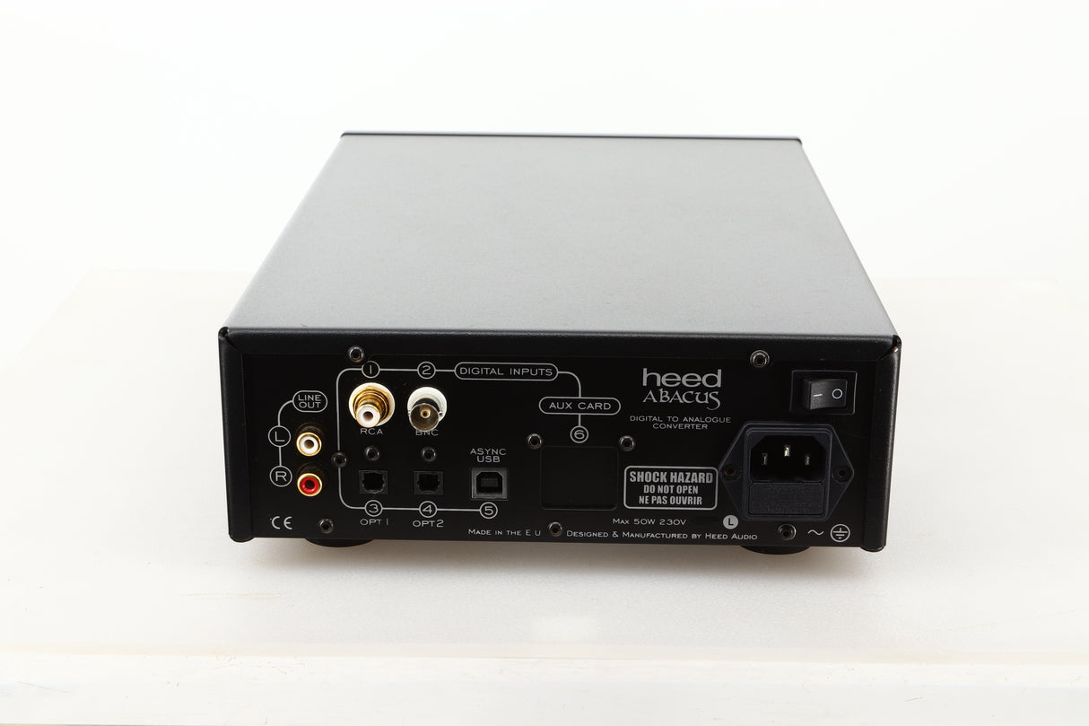 Rear view of a used Heed Abacus DAC in Black finish showing RCA outputs, RCA, BNC, optical, USB, and mains inputs