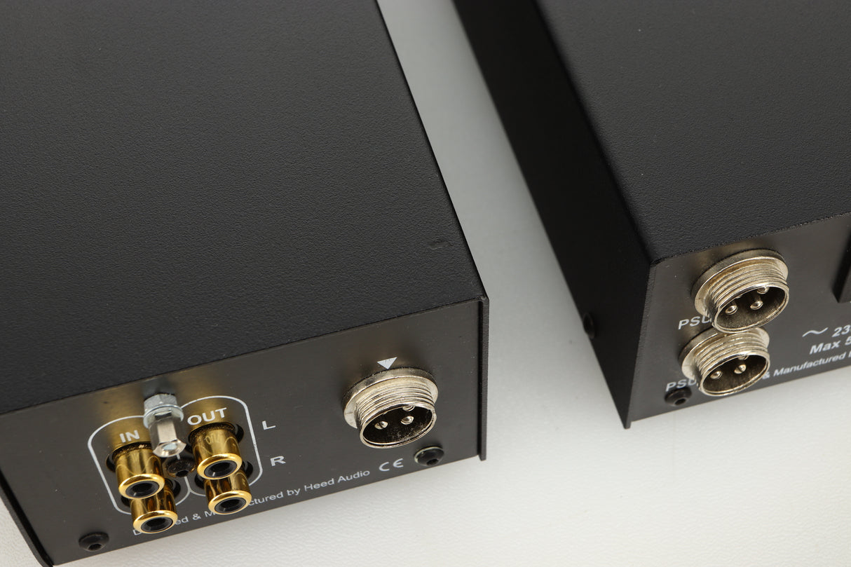 Front view of a used Heed Questar MM Phonostage with Q-PSU III Power Supply showing a small dent towards the back of the phonostage