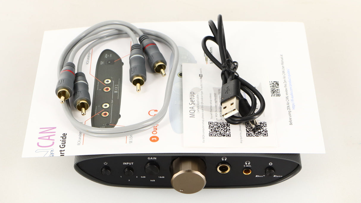 Top of a used iFi Audio Zen Air Can Headphone Amplifier showing USB Cable, Manual and Interconnect Cable