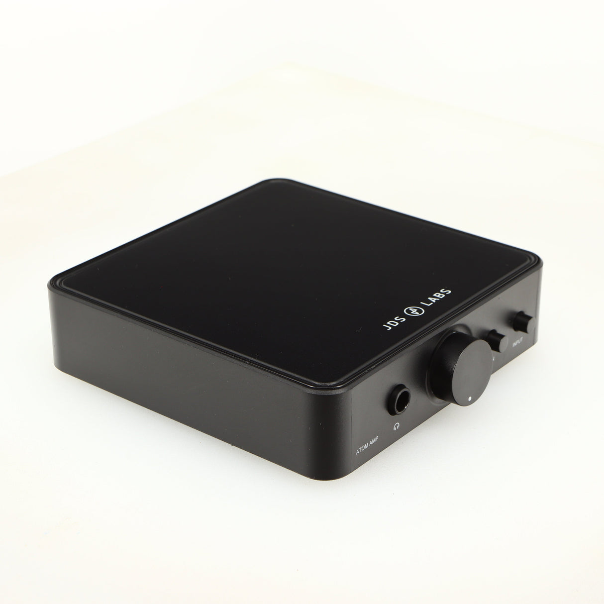 Front left corner of a used JDS Labs Atom Headphone Amplifier in a black finish
