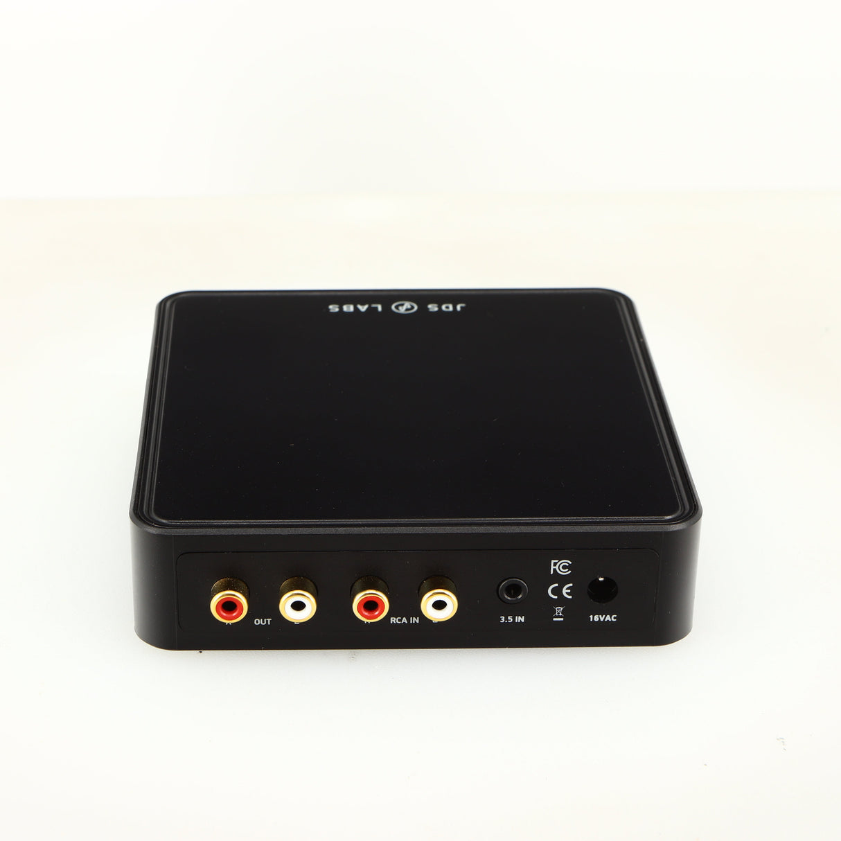 Rear view of a used JDS Labs Atom Headphone Amplifier in a black finish showing Phono Inputs, Phono Outputs and Power Input