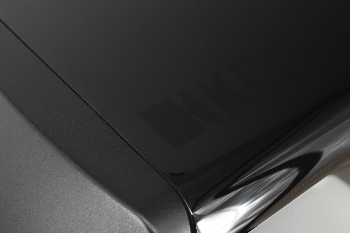 Close up of a used KEF LS50 Standmount Speaker in a black gloss finish showing a scratch on top