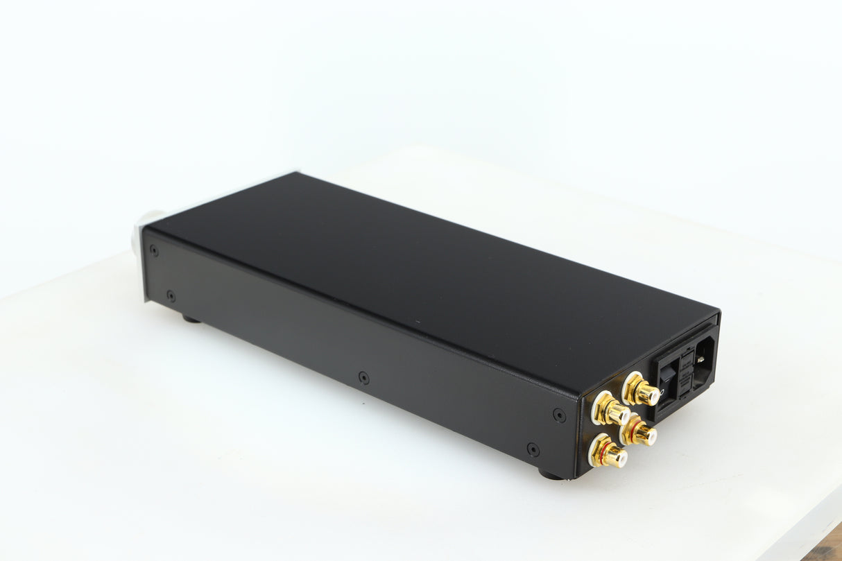 Rear right corner of a used Lehmann Black Cube Linear Headphone Amplifier in a silver finish