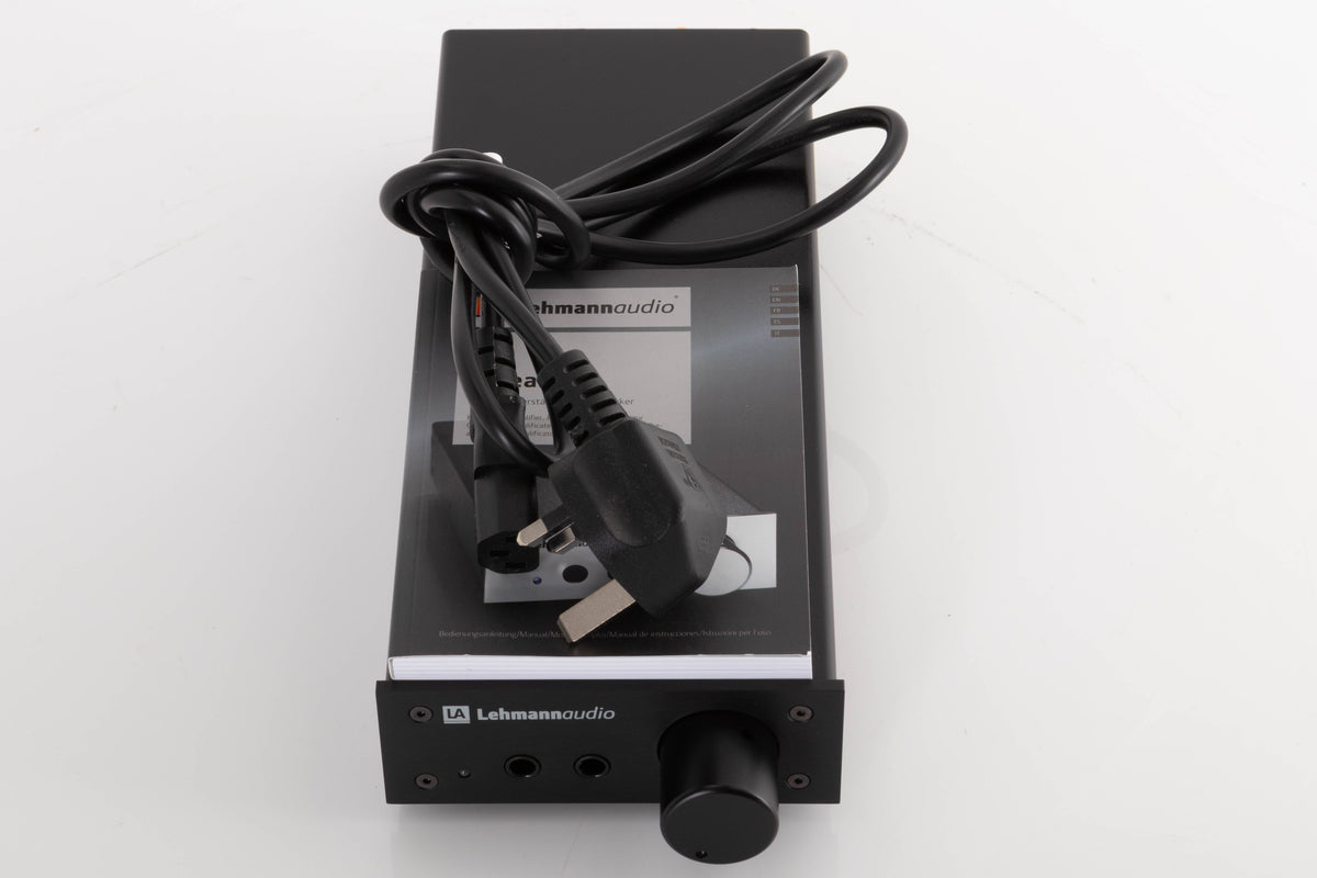 Top of a used Lehmann Linear Headphone Amplifier in a Black finish showing Manual and Mains Cable