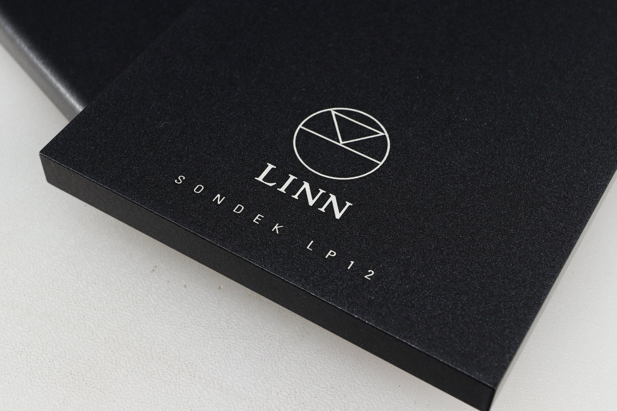 Close up of a used Linn Kore For Ekos LP12 Sub Chassis in a black finish showing logo