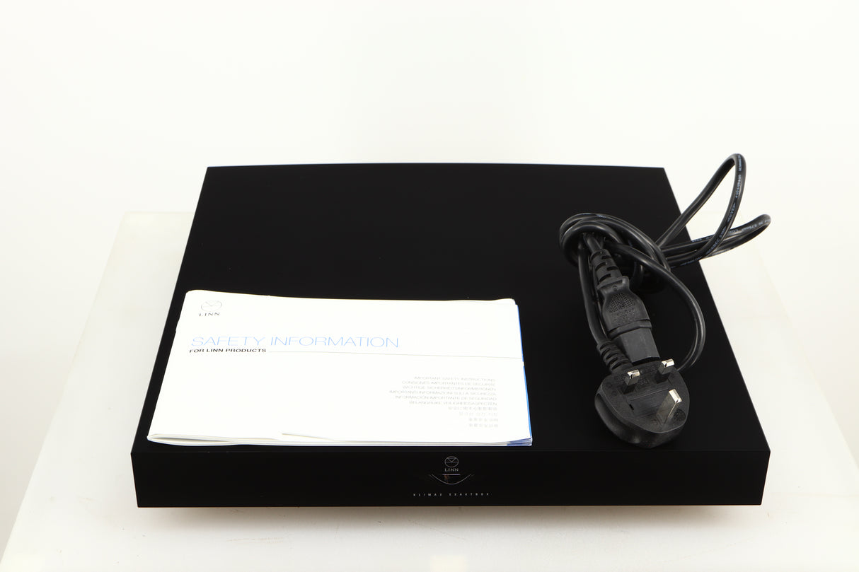 Top of a used Linn Klimax Exaktbox W/ Organic DAC in a black finish showing Mains Cable and Manual
