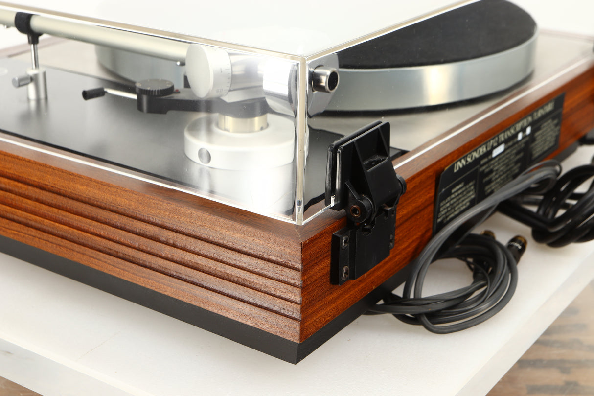 Rear right corner of a used Linn LP12 / Ittok Tonearm / Adikt Cartridge in an afromosia finish