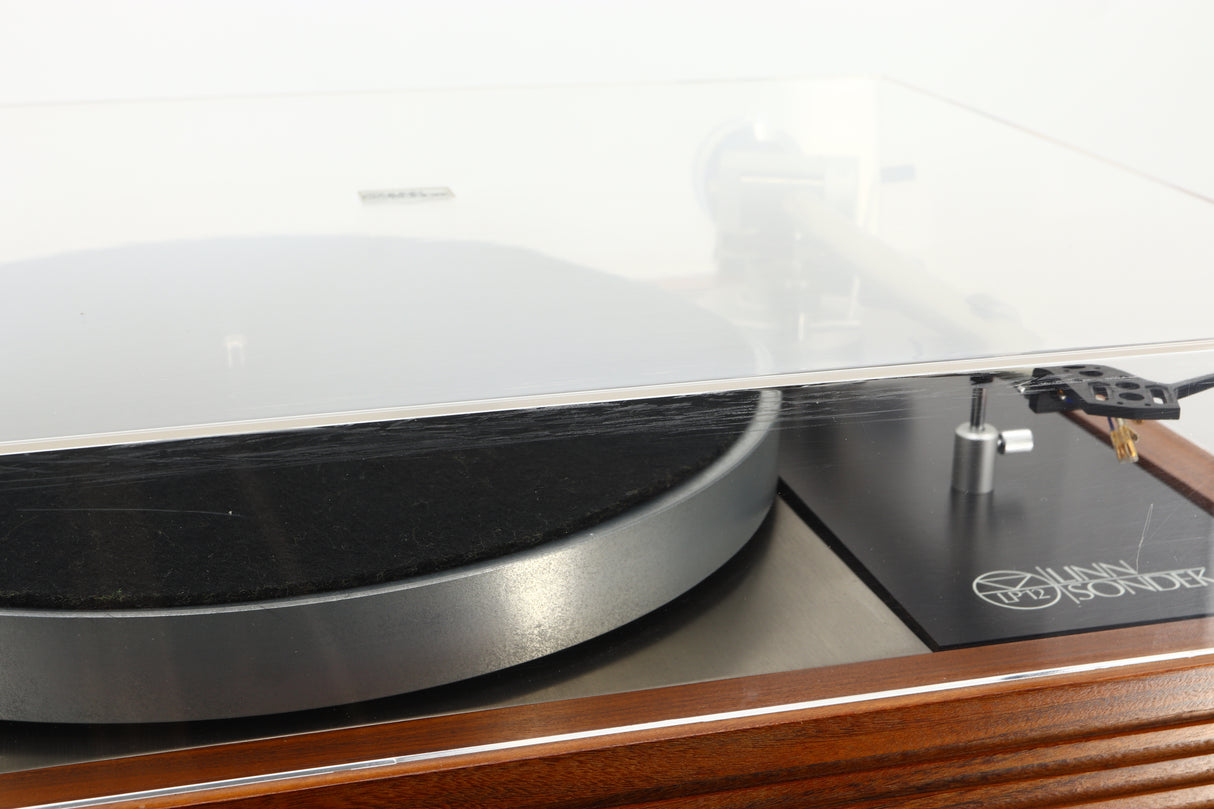 Close up of a used Linn LP12 Turntable / Ittok Tonearm / Hercules Power Supply in a afromosia finish showing scratching on the front of the lid
