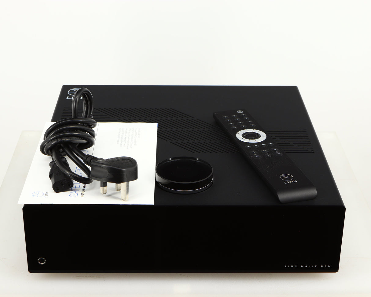 Top of a used Linn Majik DSM5 Network Music System in a black finish showing Mains Cable, Manual and Remote