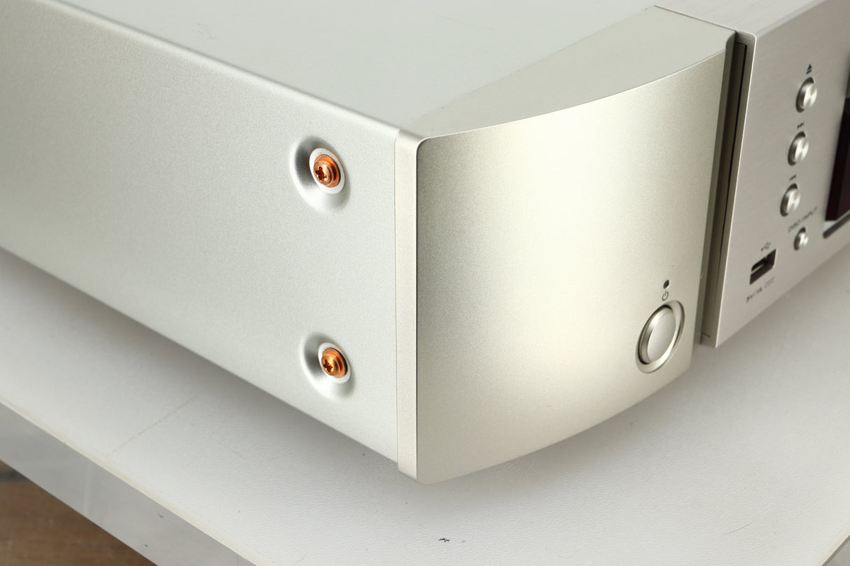 Close up view of the front left corner of a used Marantz CD6007 CD Player in silver finish