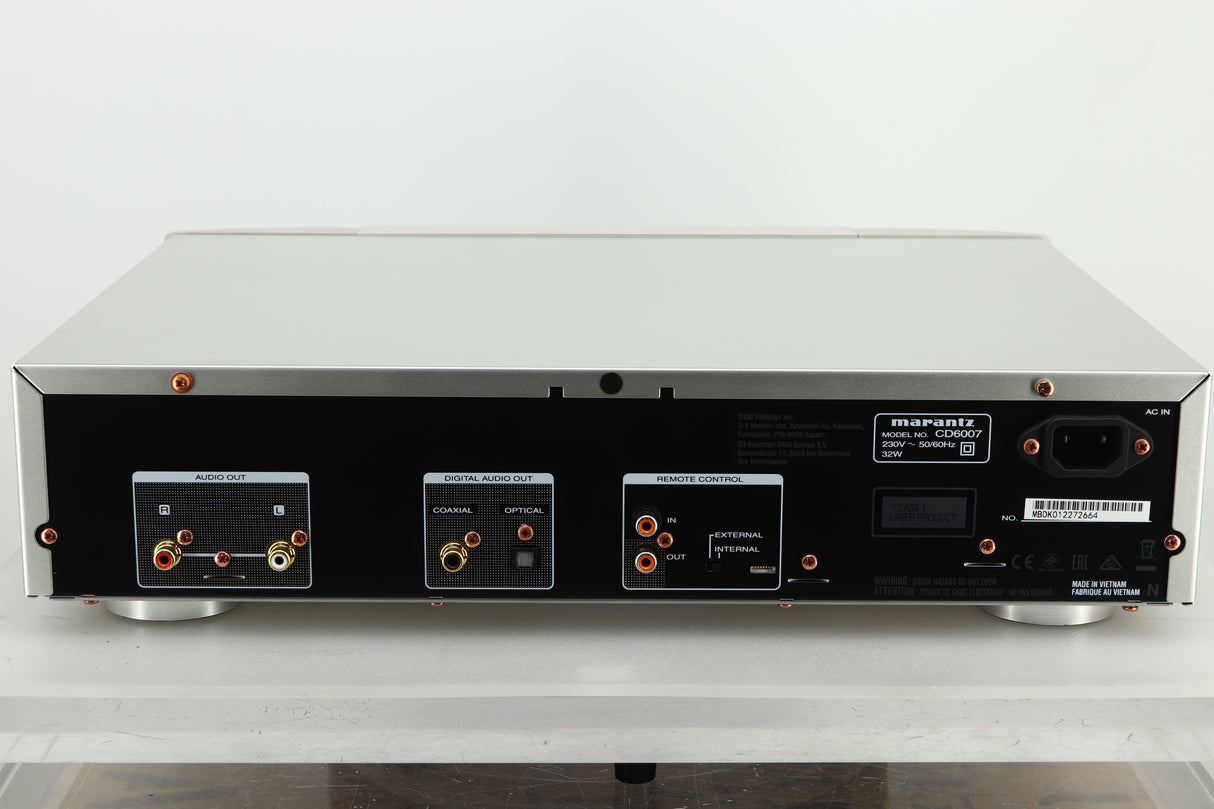 Rear view of a used Marantz CD6007 CD Player in silver finish showing RCA outputs, coaxial and optical inputs, and a power input