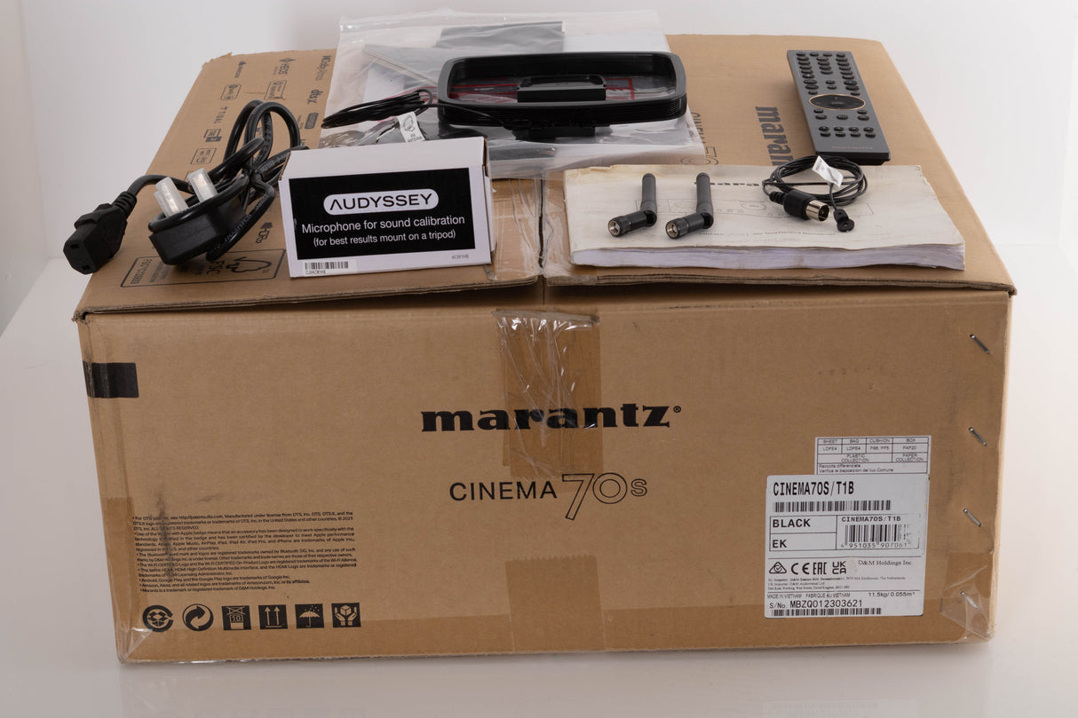 Box of a used Marantz Cinema 70s AV Amplifier in Black with Mains Cable, Manual, Remote, 2x Antenna, AM/FM Aerials, Audyssey Setup Mic, and Mic Stand