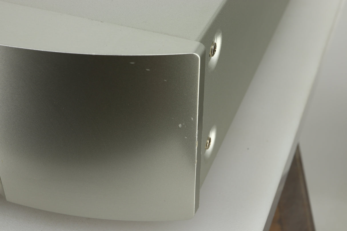 Close up view of the fascia of a used Marantz NA6005 Network Player in silver finish showing small dents