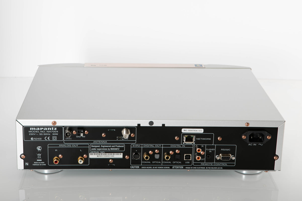 Rear view of a used Marantz NA7004 Network Streamer in a Silver finish showing Mains Input, Phono Inputs, Phono Outputs, Network Input, Optical Input and Optical Output