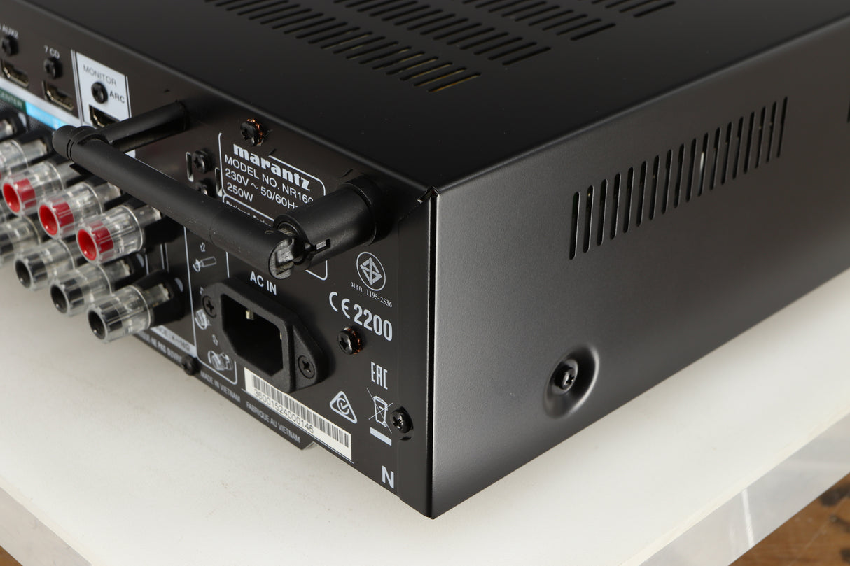 Rear left corner of a used Marantz NR1606 AV Receiver in a black finish