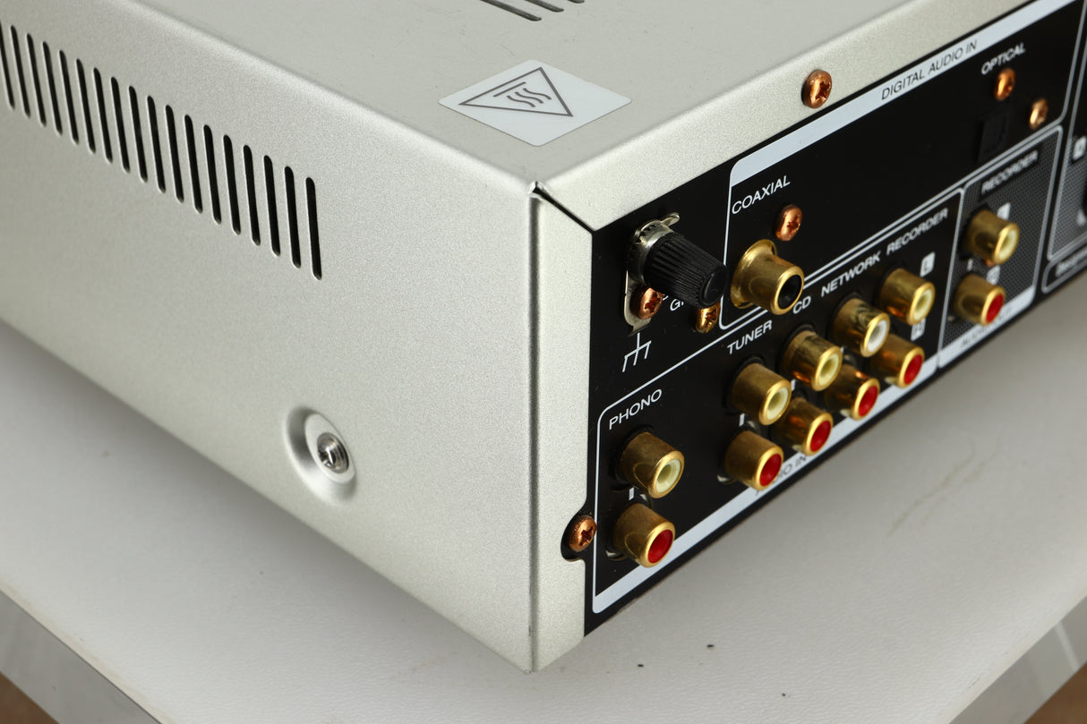 Close up view of the rear left corner of a used Marantz PM6005 Integrated Amplifier in silver finish