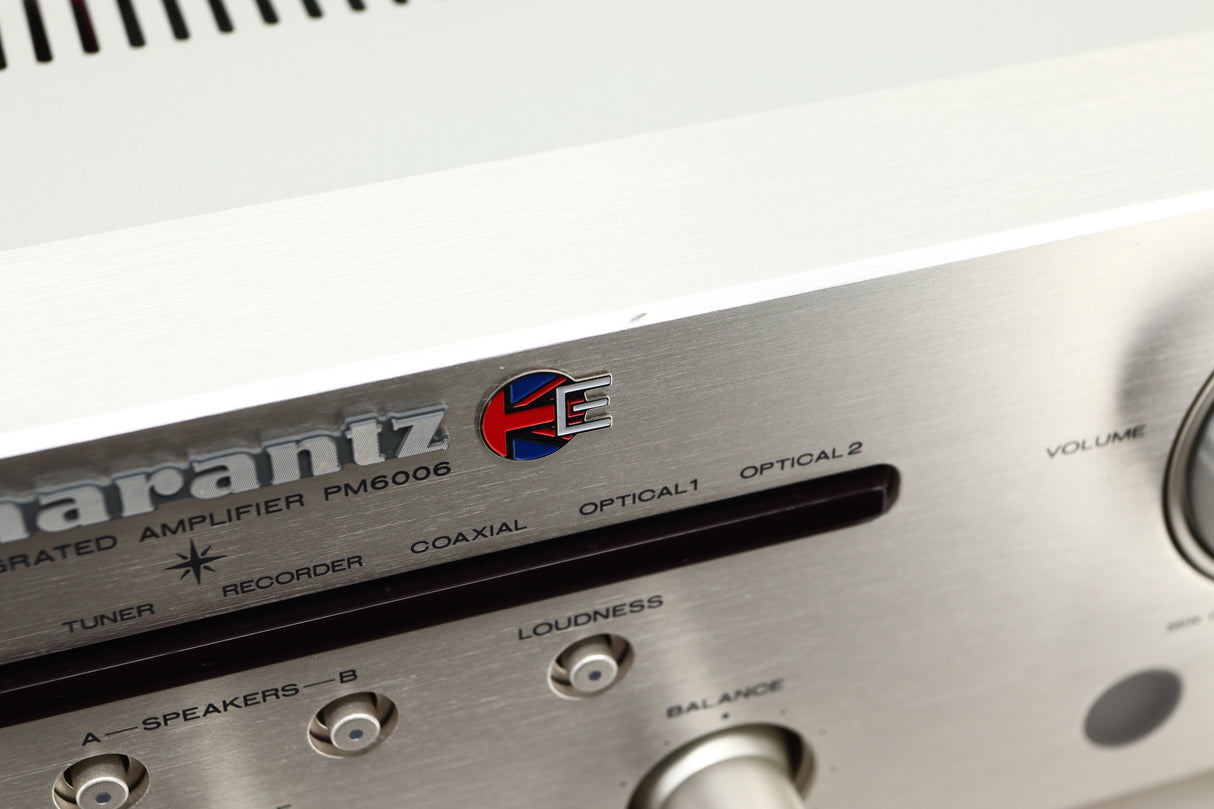 Close up view of a used Marantz PM6006 UK Edition Integrated Amplifier in Silver finish showing scratching on the front edge