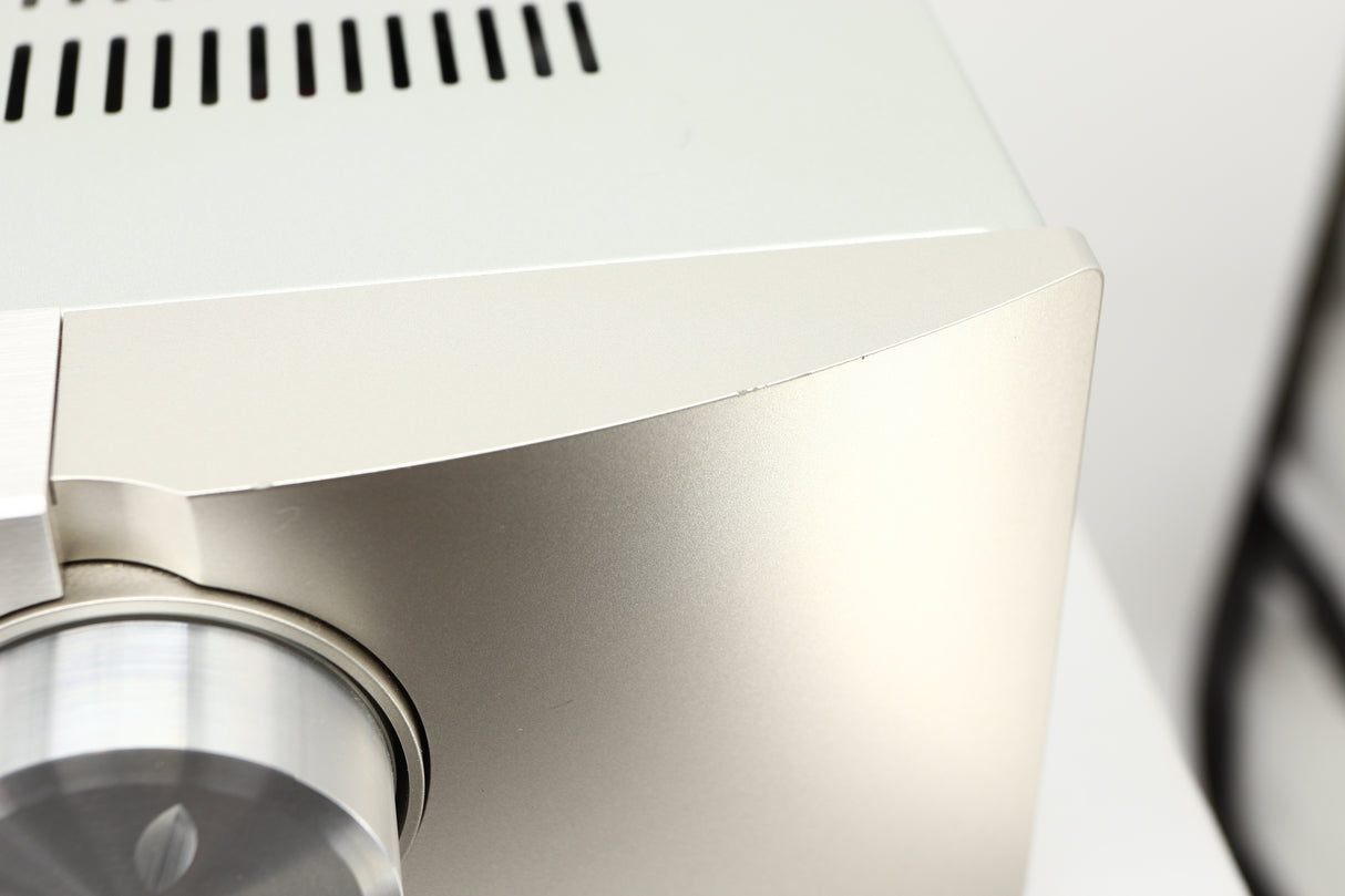 Close up view of a used Marantz PM6006 UK Edition Integrated Amplifier in Silver finish showing scratching on the front edge on the right side