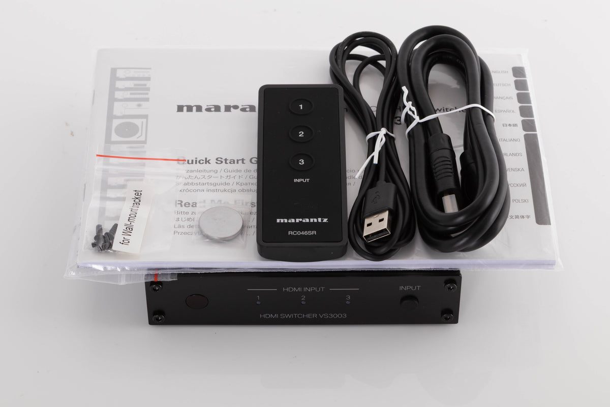 Top of a used Marantz VS3003 3 Port HDMI Switch in a Black finish showing Manual, Screws, Remote, Battery, USB Cable and HDMI Cable