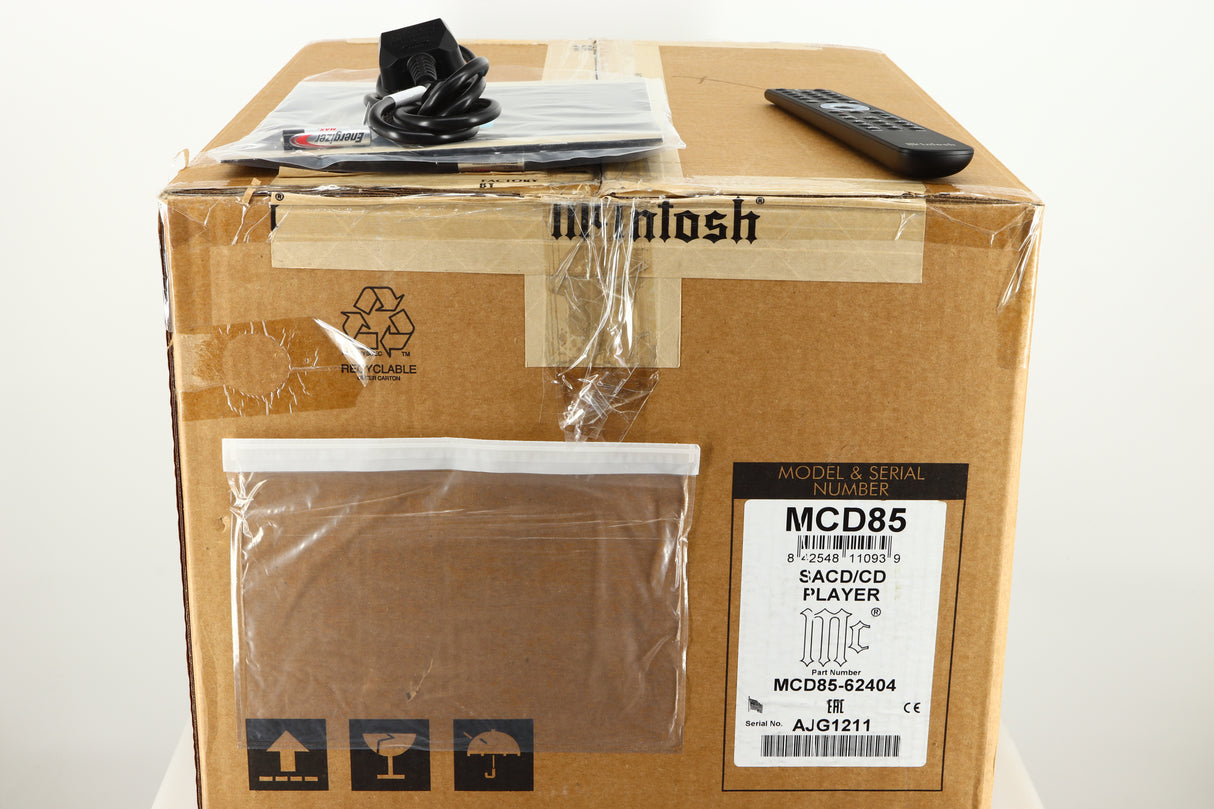 Box for a used McIntosh MCD85 CD / SACD Player in a silver / black finish showing Remote, Mains Cable, Batteries and Manual