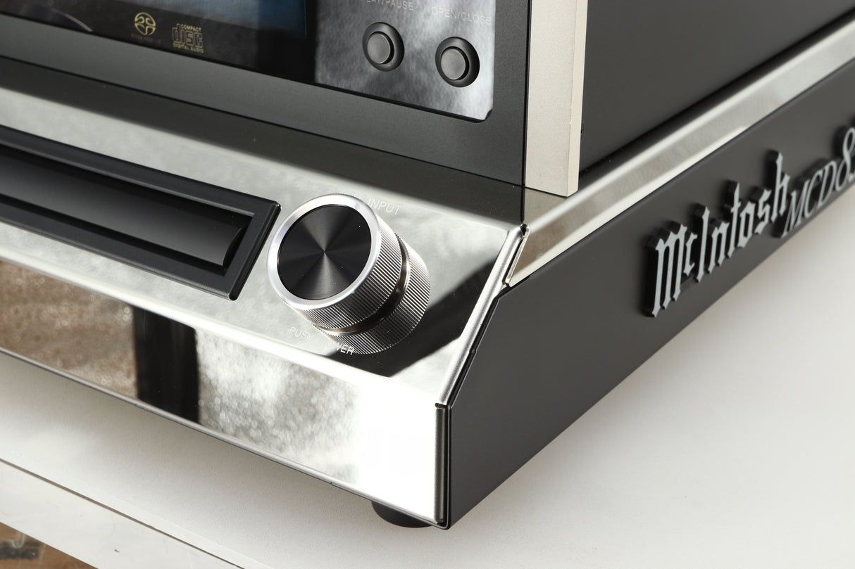 Front right corner of a used McIntosh MCD85 CD / SACD Player in a silver / black finish