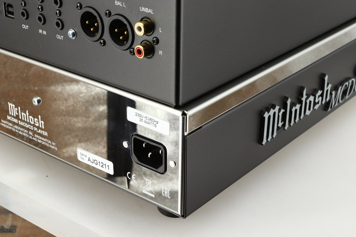 Rear left corner of a used McIntosh MCD85 CD / SACD Player in a silver / black finish