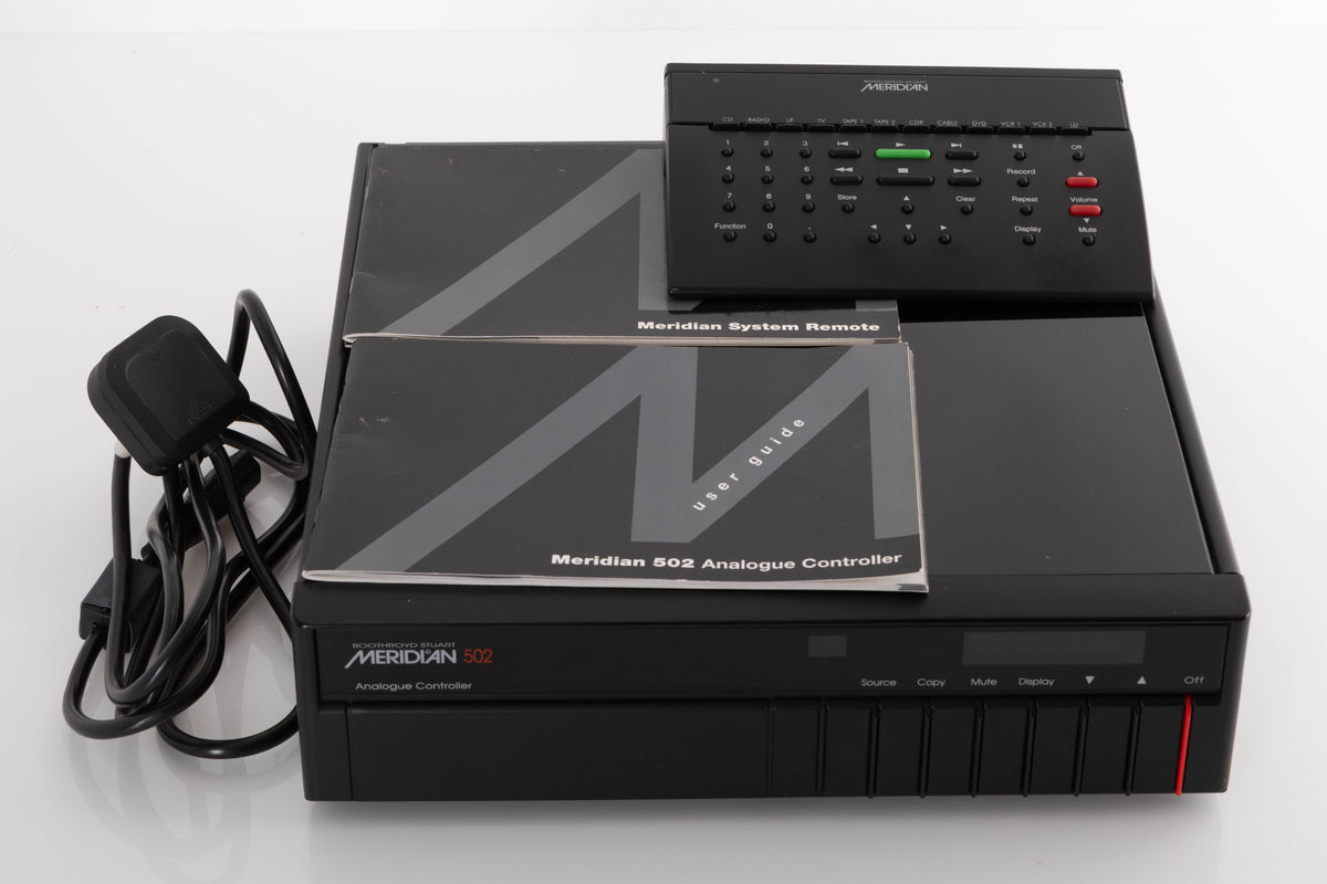 Front view of a used Meridian 502 Pre Amplifier with mains cable, manual, and MSR System Remote