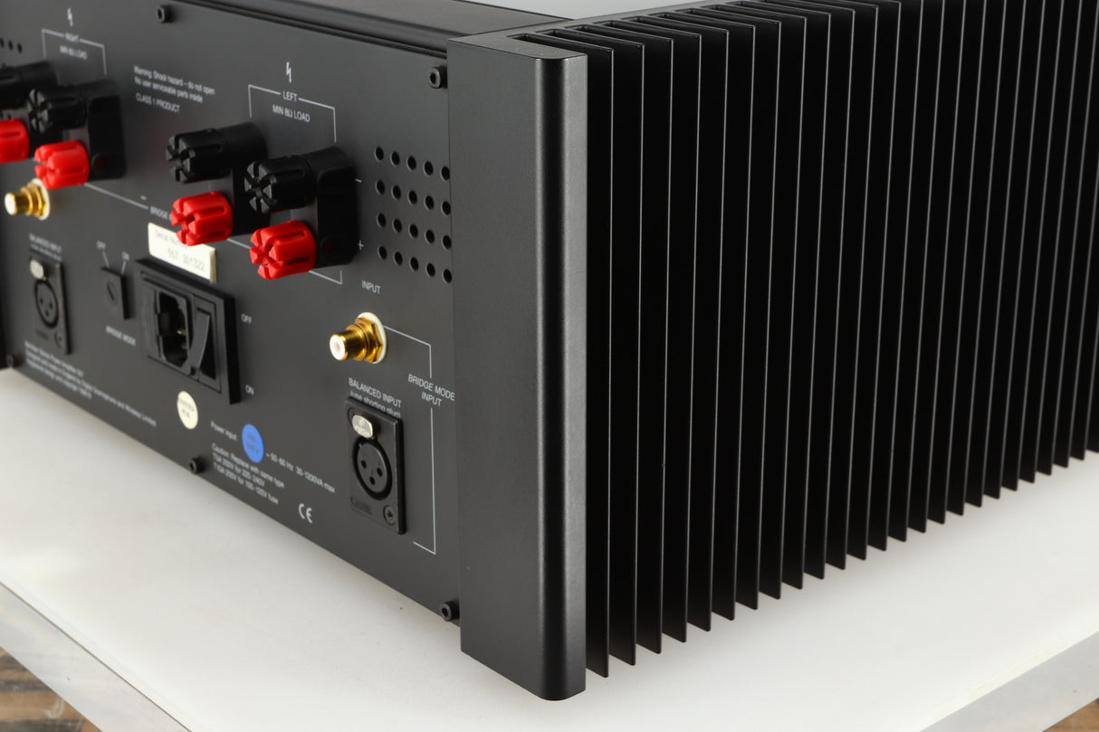Rear left corner of a used Meridian 557 Power Amplifier in a black finish