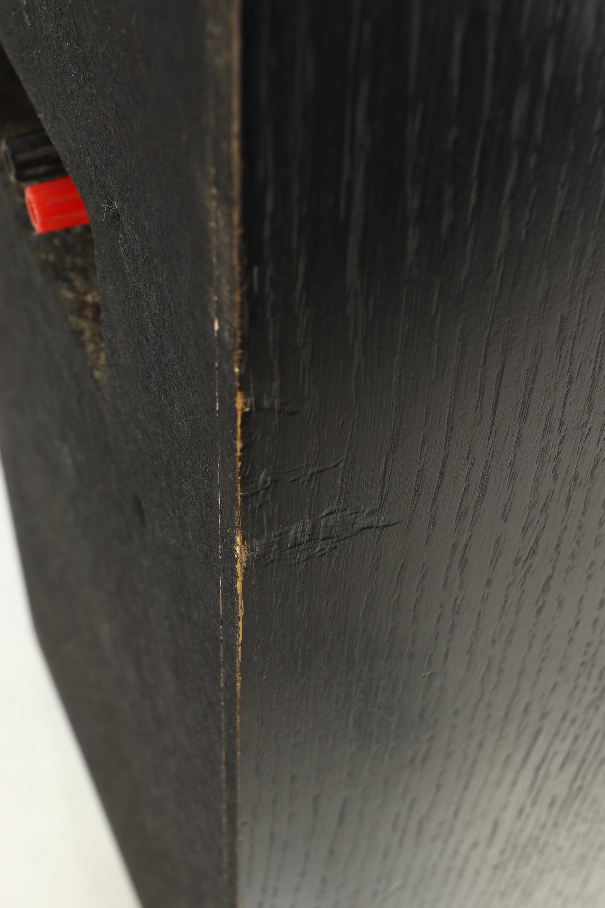 Close up view of a used Monitor Audio R352 Standmount Speakers in Black Ash finish showing denting on the side