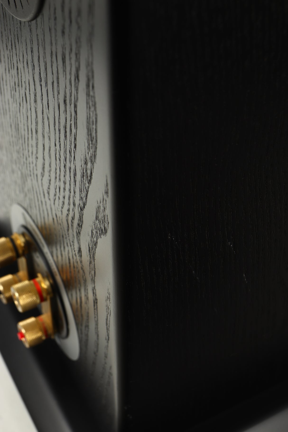 Close up of a used Monitor Audio Silver 8 Floorstanding Speaker in a black oak finish showing scratching on left side