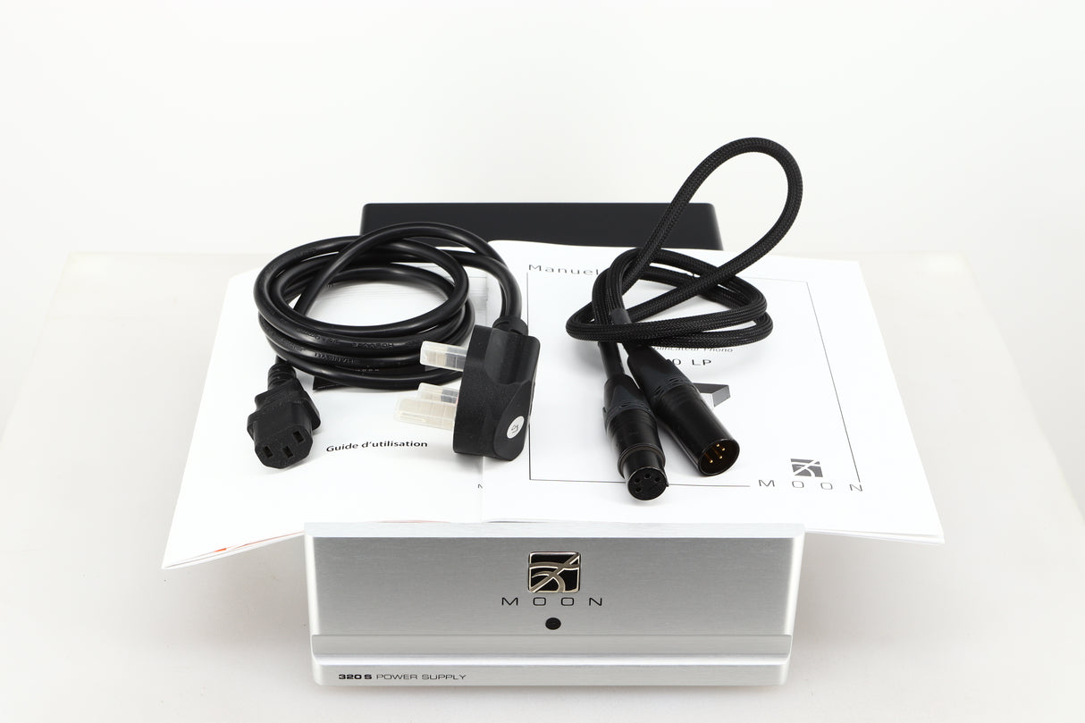 Top view of a used Moon 320S Power Supply in a silver finish showing Mains Cable, DIN Cable and Manuals