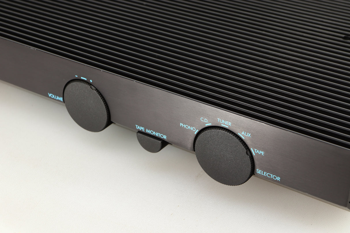 Close up of a used Musical Fidelity B200 Integrated Amplifier in a black finish showing scratching along front edge