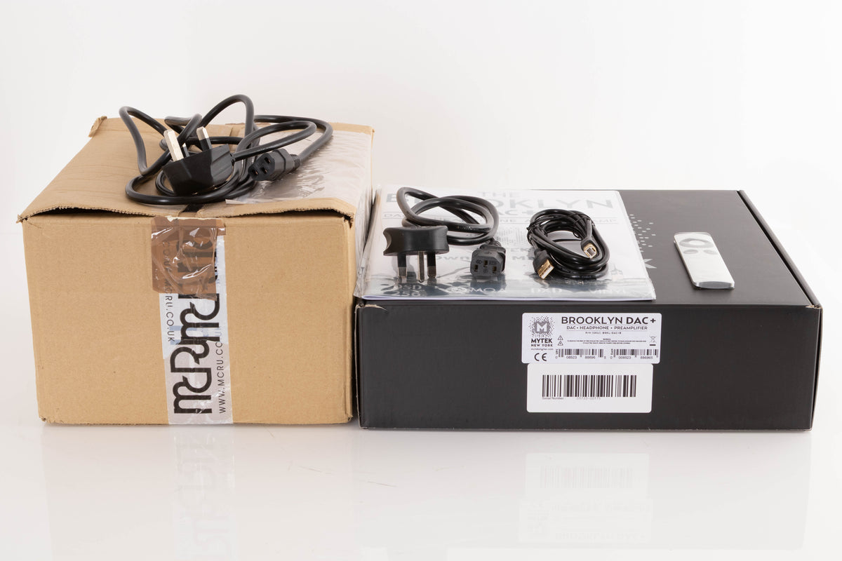 Box of a used Mytek Brooklyn DAC+ Digital Analogue Converter and MCRU Power Supply with mains cables, USB cable, manual, and Apple remote