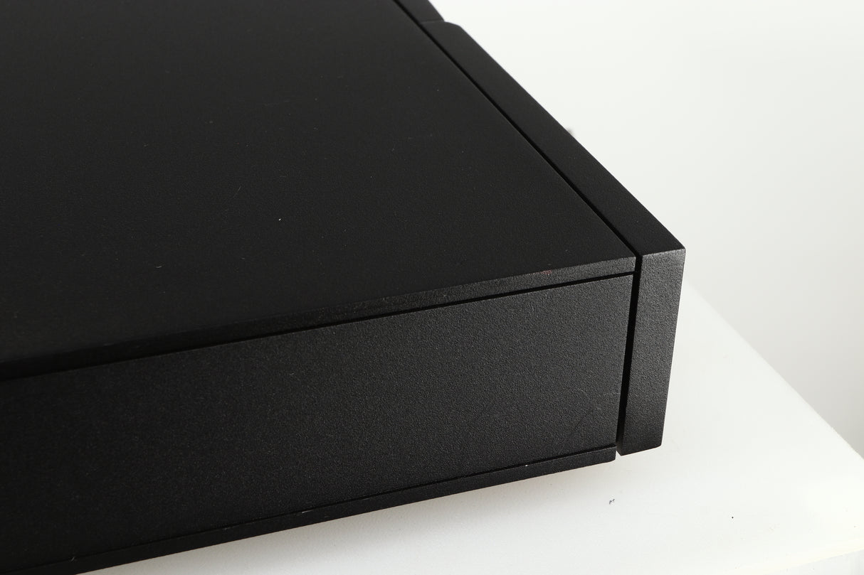 Close up of a used Naim CD5 CD Player in a black finish showing some scratches