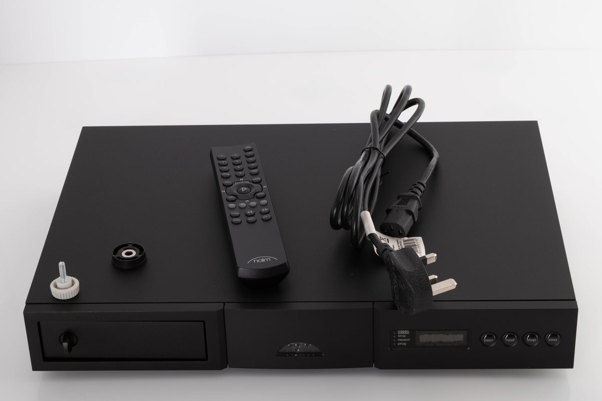 Top of a used Naim CD5 XS CD Player in a Black finish showing Remote, Batteries, CD Puck, Transit Bolt and SNAIC5