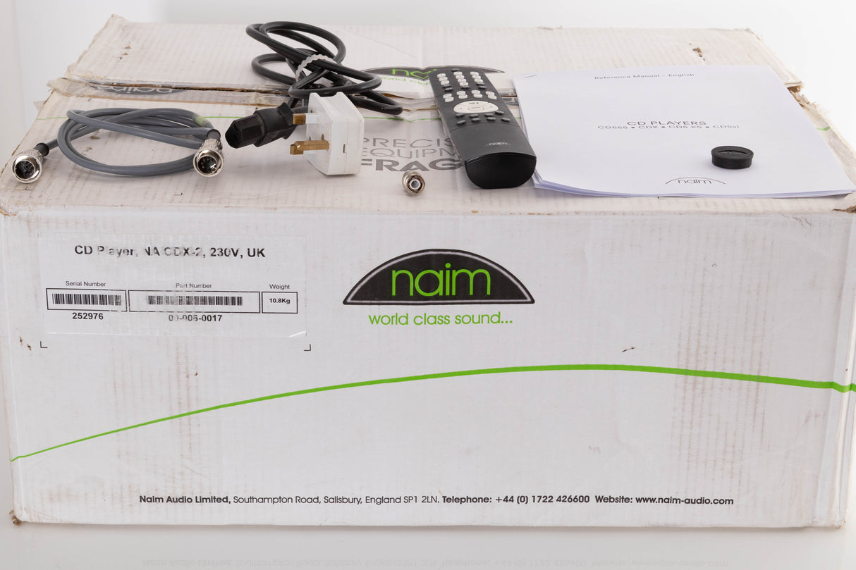 Box of a used Naim CDX2 CD Player with mains cable, remote, SNAIC, CD puck, and BNC adaptor