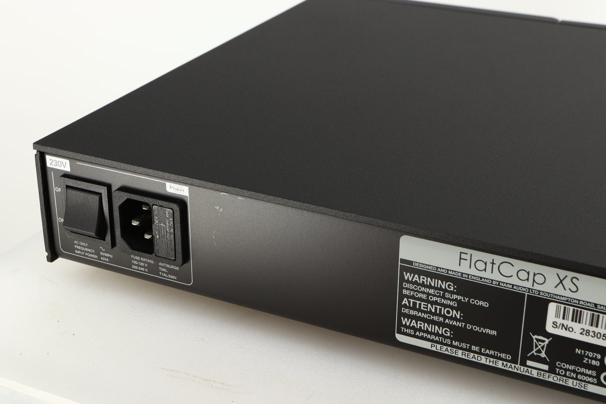 Close up of a used Naim Flatcap XS Power Supply in a black finish showing scratching on rear