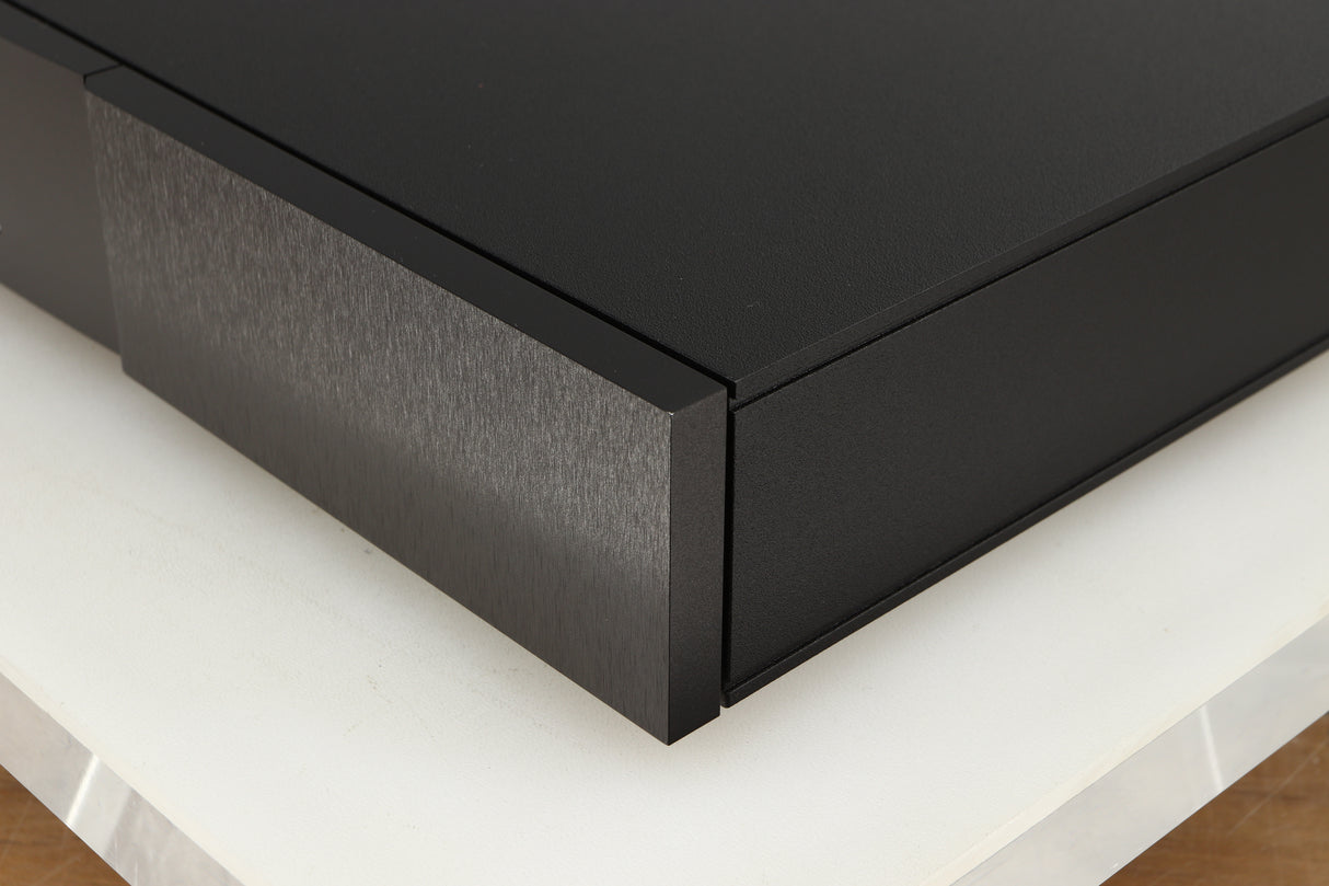 Front right corner of a used Naim Flatcap XS Power Supply in a black finish