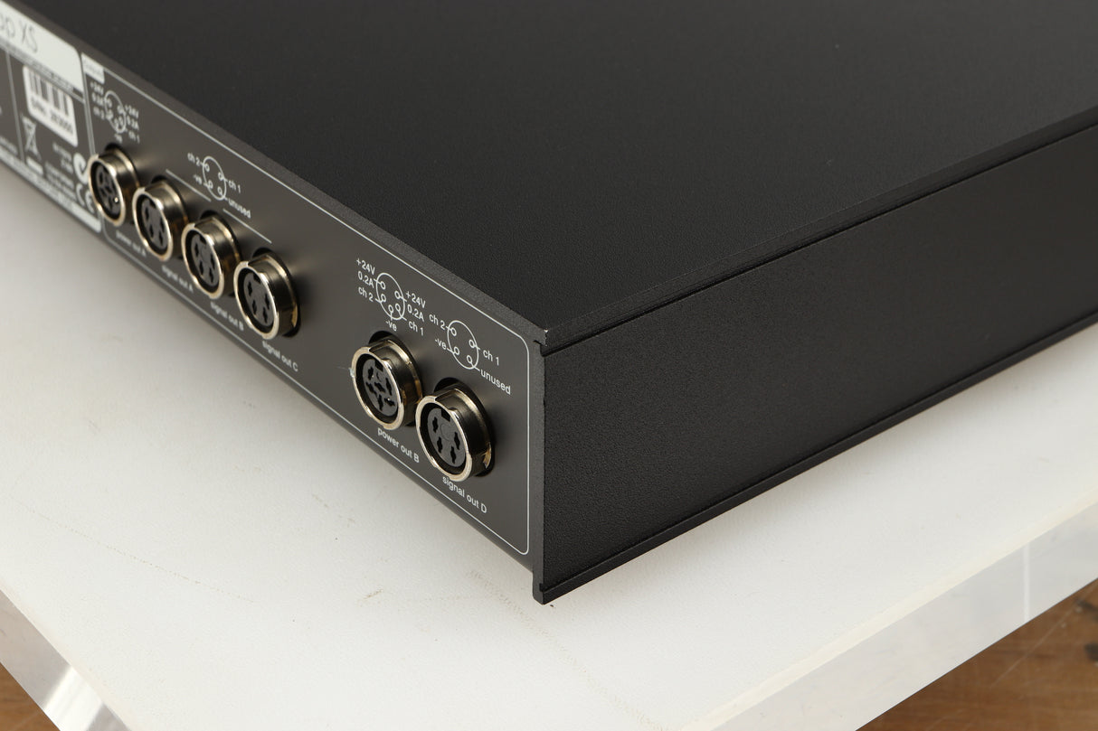 Rear left corner of a used Naim Flatcap XS Power Supply in a black finish