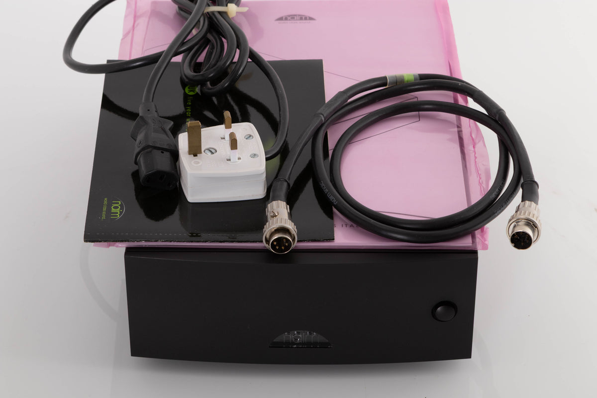 Top of a used Naim Hicap DR Power Supply in a Black finish showing Mains Cable, SNAIC5 and Manual