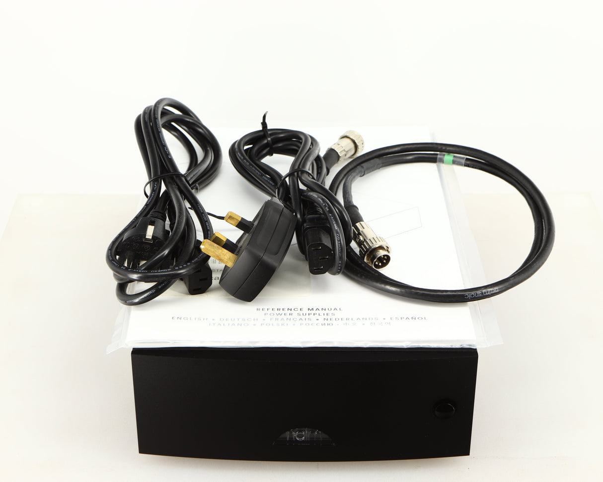 Top of a used Naim Hicap DR Power Supply in a black finish showing Manual, SNAIC5, Mains Cable and Schuko Cable