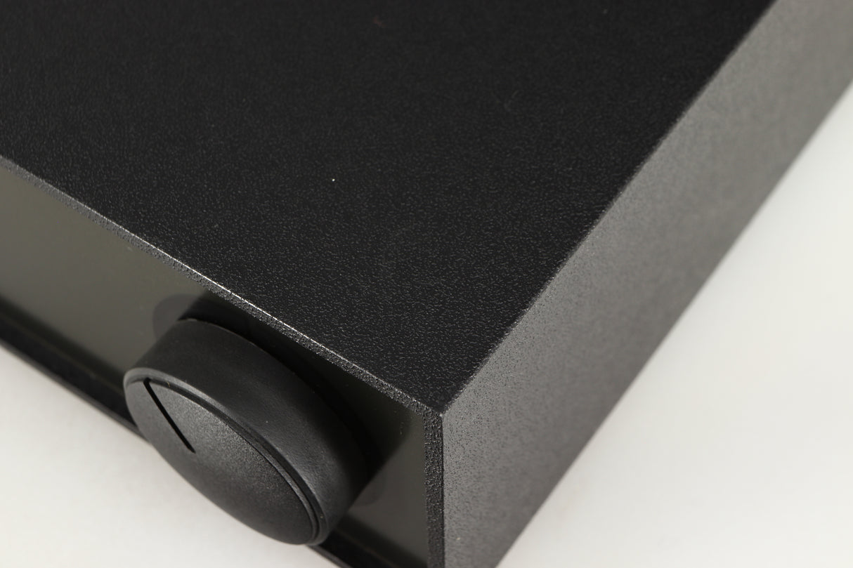 Close up of a used Naim Hicap Power Supply in a black finish showing mark on top