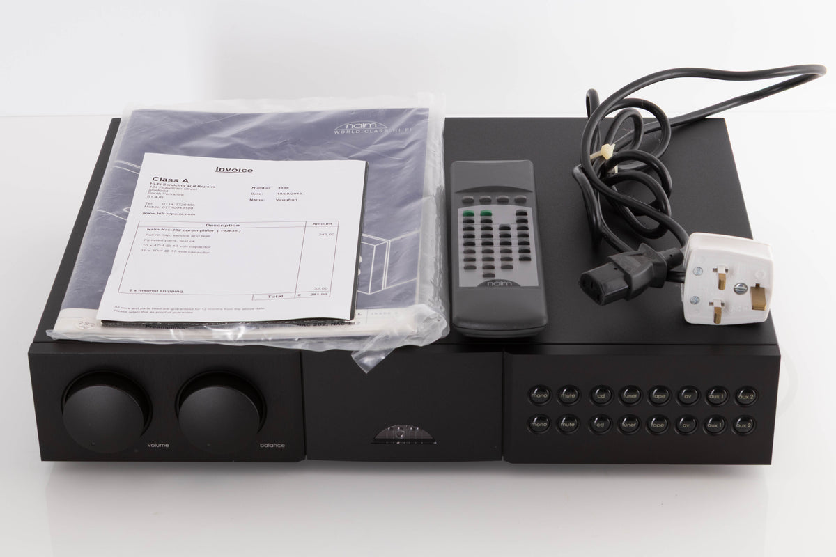 Top of a used Naim NAC282 Pre Amplifier in a Black finish showing Manual, Remote and Mains Cable