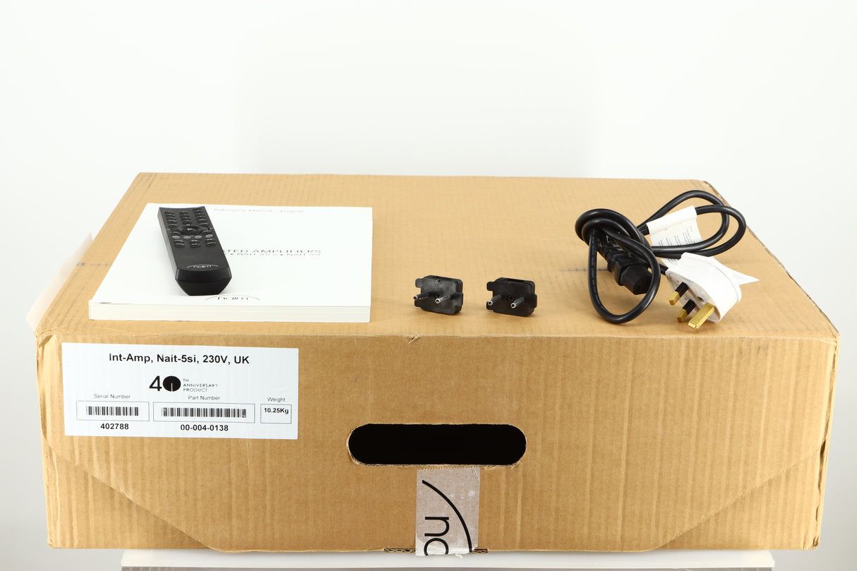 Box of a used Naim NAIT 5si Integrated Amplifier showing a remote, 2x link plugs, battery, mains cable and manual