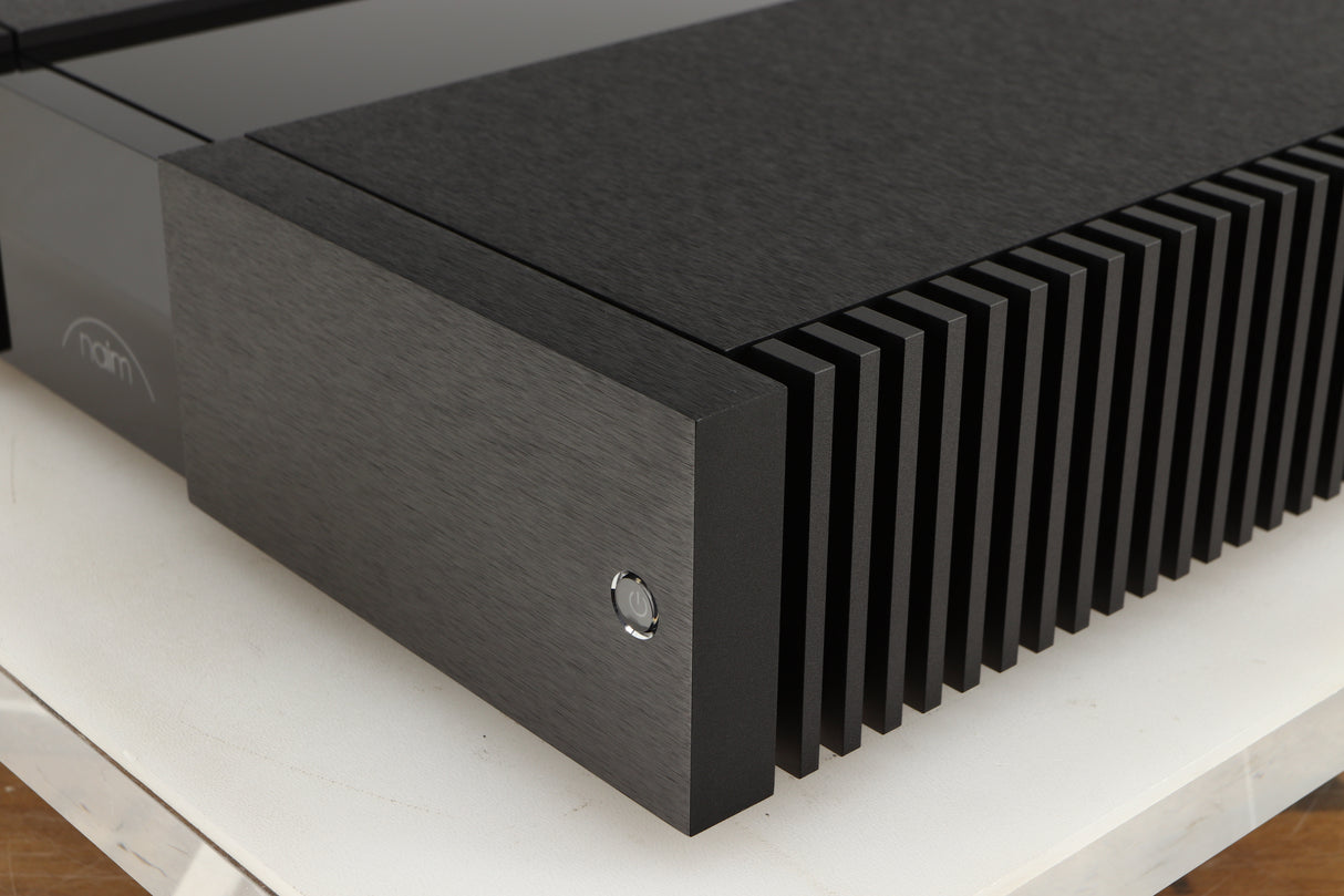 Front right corner of a used Naim NAP 250 Power Amplifier in a black finish