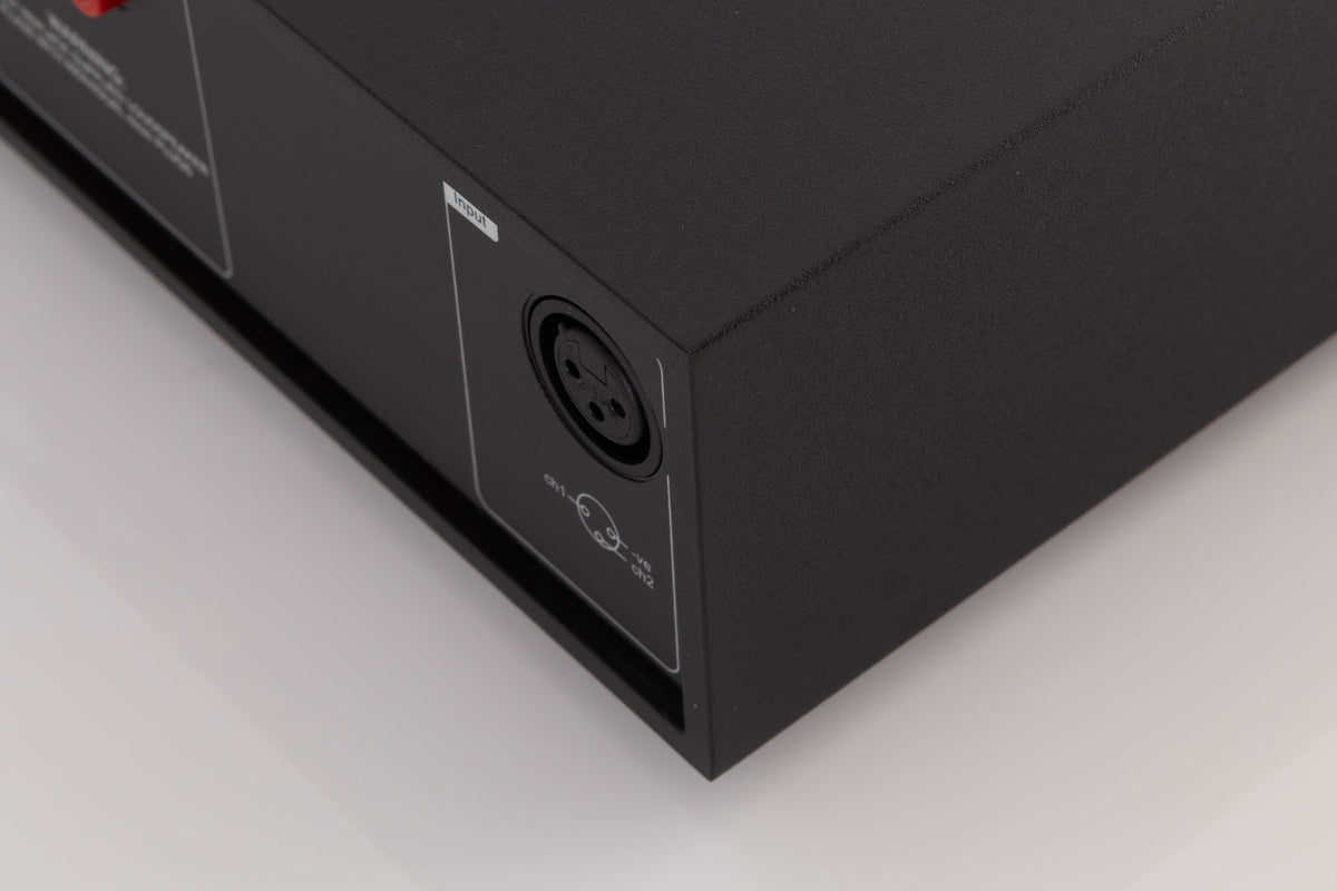 Rear left corner of a used Naim NAP250 DR Power Amplifier in a Black finish