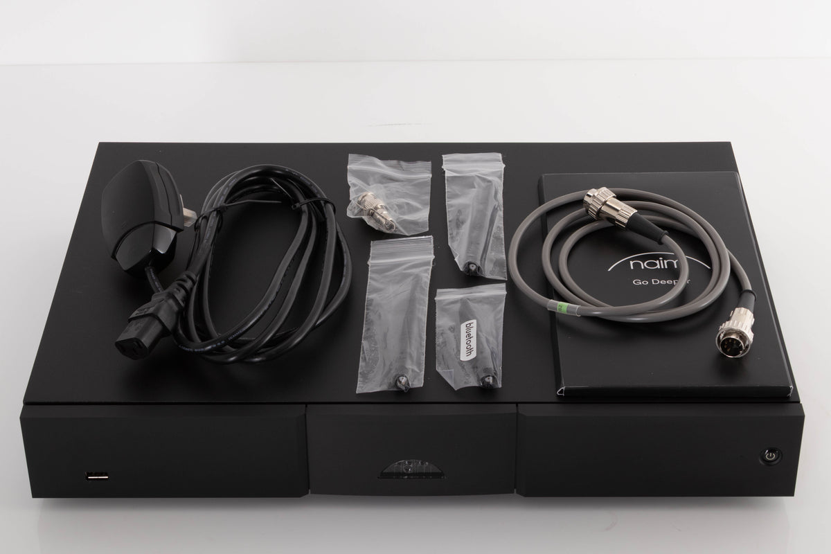 Top of a used Naim ND5 XS2 Media Player in a Black finish showing Manual, SNAIC5, Mains Cable, Wi-Fi Antennas, Bluetooth Antenna and BNC Adaptor
