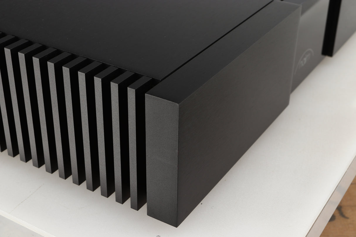 Front left corner of a used Naim New Classic NAP250 Power Amplifier in a black finish