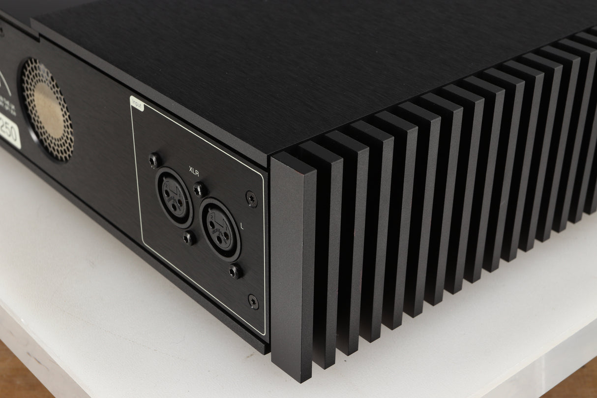 Rear left corner of a used Naim New Classic NAP250 Power Amplifier in a black finish