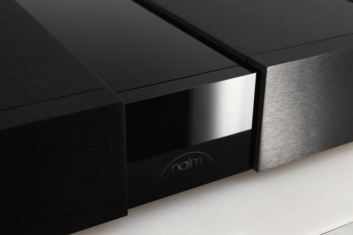 Close up of a used Naim NPX300 Power Supply in a black finish showing a light scratch on fascia